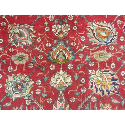 878 - A red ground Tabriz rug