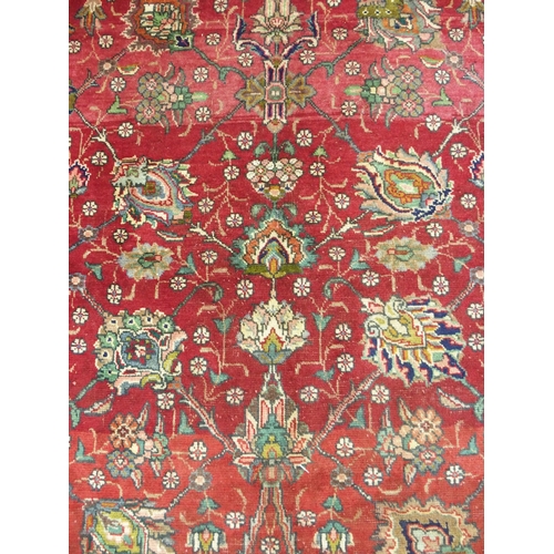 878 - A red ground Tabriz rug