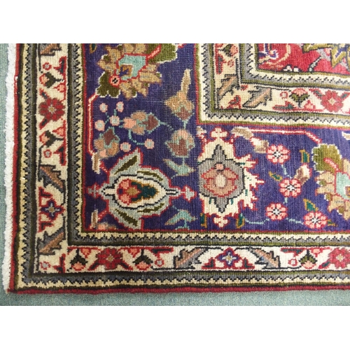 878 - A red ground Tabriz rug