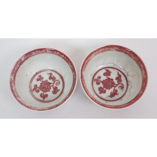 99 - A pair of Chinese copper red teabowls