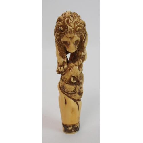 28 - A Japanese carved ivory cane handle