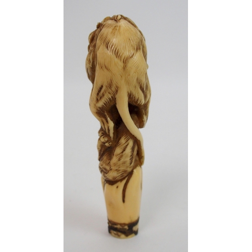 28 - A Japanese carved ivory cane handle