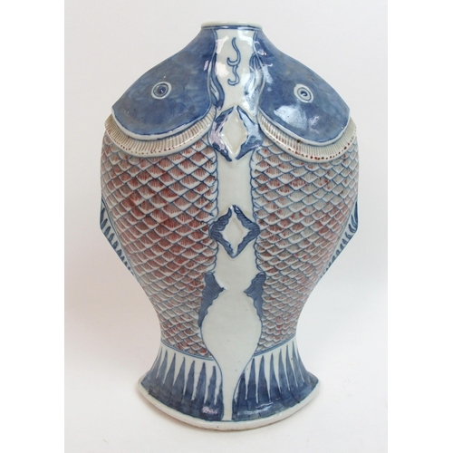 41 - A Chinese relief moulded double fish vase