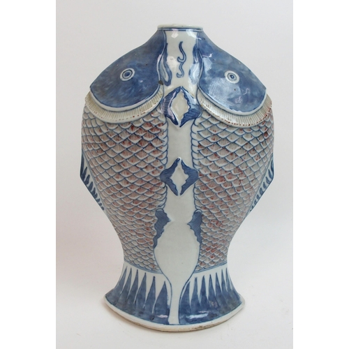 41 - A Chinese relief moulded double fish vase