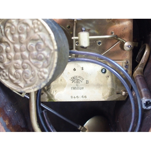 552 - A late 19th century / early 20th century walnut mantle clock