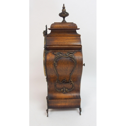 552 - A late 19th century / early 20th century walnut mantle clock