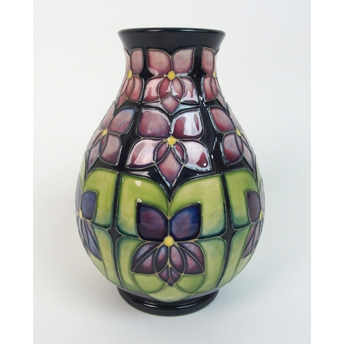 564 - A Moorcroft Violet pattern vase