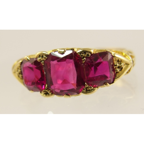 620 - An 18ct gold three stone ruby ring