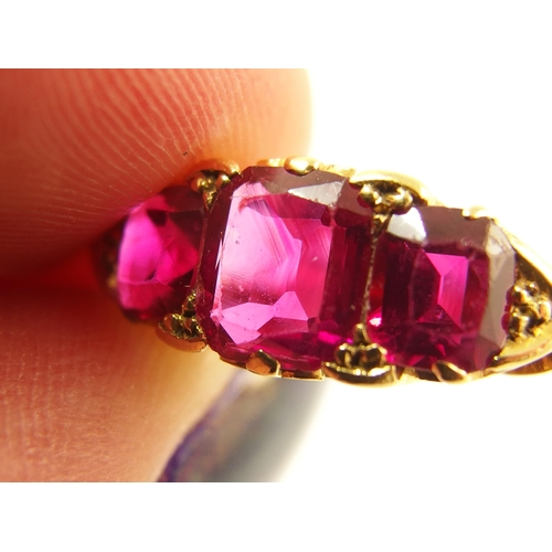 620 - An 18ct gold three stone ruby ring