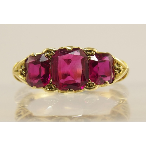 620 - An 18ct gold three stone ruby ring