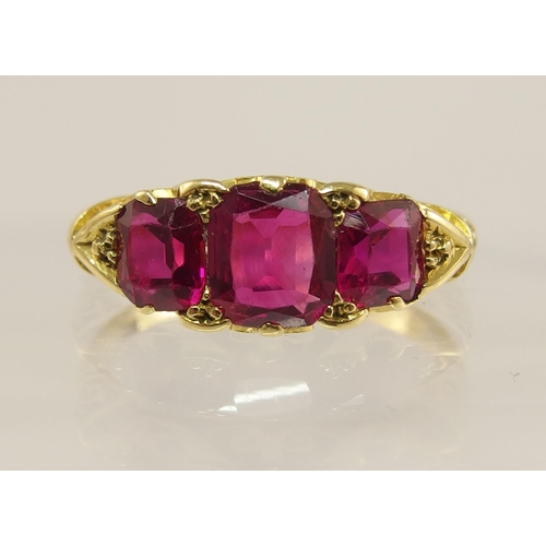 620 - An 18ct gold three stone ruby ring