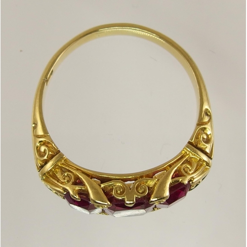 620 - An 18ct gold three stone ruby ring