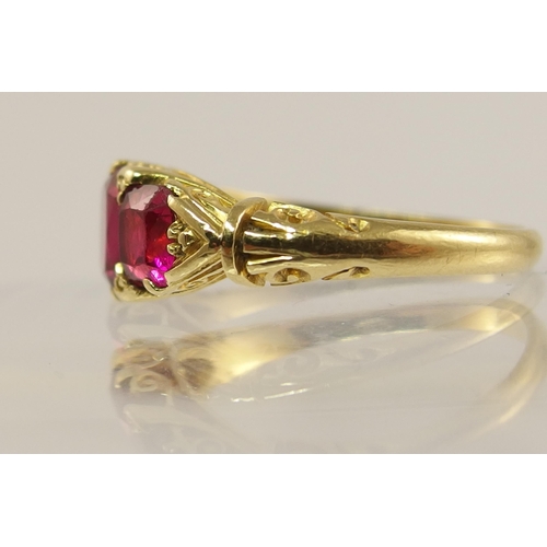 620 - An 18ct gold three stone ruby ring