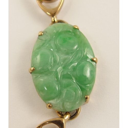 622 - A 9ct gold Chinese green hardstone bracelet