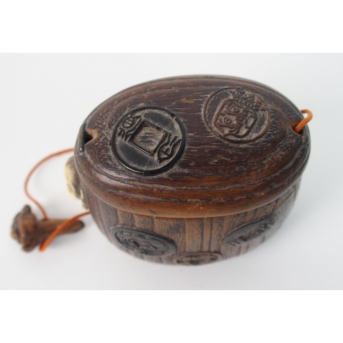 63 - A Chinese carved wood tobacco pouch and cover