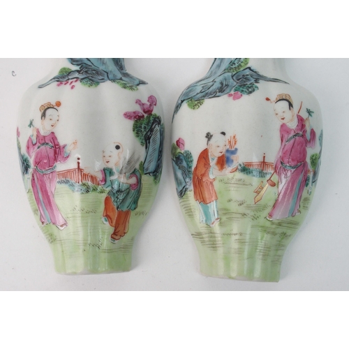 64 - A pair of Canton famille rose vase shaped wall plaques