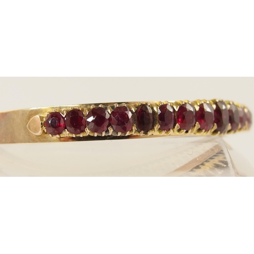 654 - A graduated oval mixed cut ruby set bangle