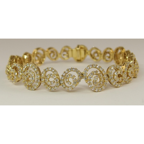 655 - An 18ct gold diamond bracelet of spiral forms