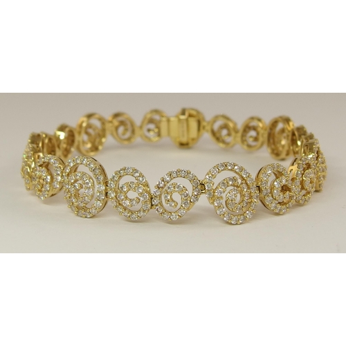 655 - An 18ct gold diamond bracelet of spiral forms