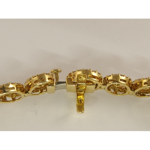 655 - An 18ct gold diamond bracelet of spiral forms