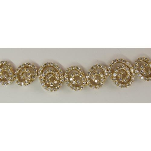 655 - An 18ct gold diamond bracelet of spiral forms