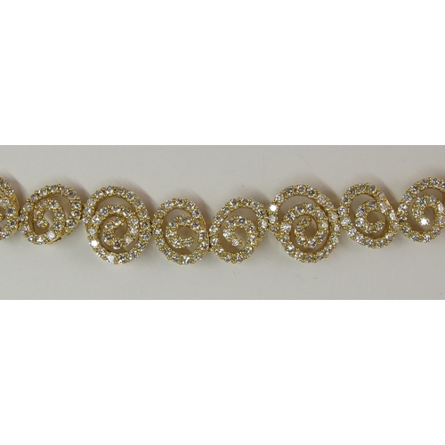 655 - An 18ct gold diamond bracelet of spiral forms