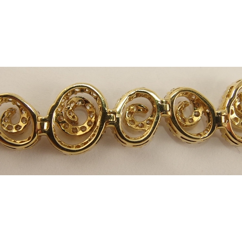 655 - An 18ct gold diamond bracelet of spiral forms