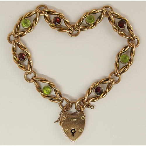 688 - A 9ct rose gold fancy knot link bracelet set with peridots and garnets