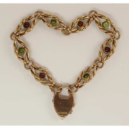 688 - A 9ct rose gold fancy knot link bracelet set with peridots and garnets