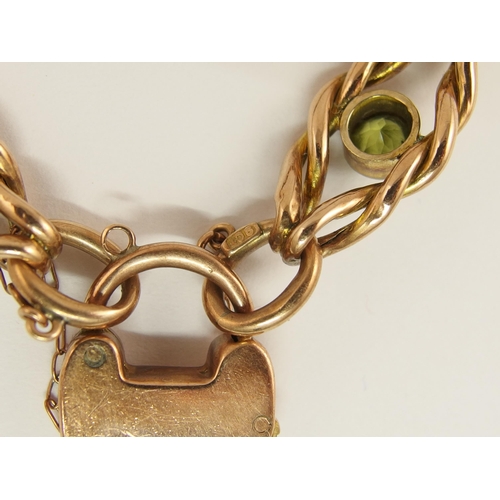 688 - A 9ct rose gold fancy knot link bracelet set with peridots and garnets