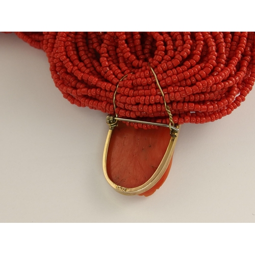 689 - A carved coral cameo necklace