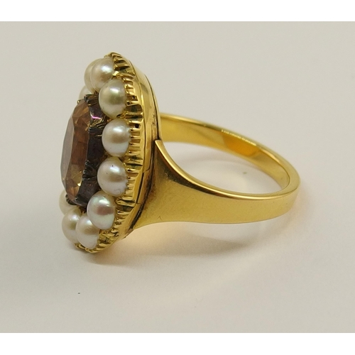 701 - A pale orange topaz and pearl ring