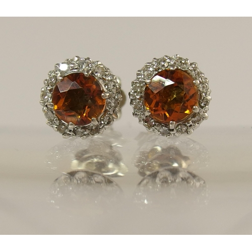 713 - A pair of 18ct diamond and citrine set stud earrings