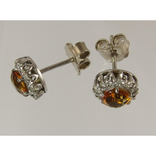 713 - A pair of 18ct diamond and citrine set stud earrings