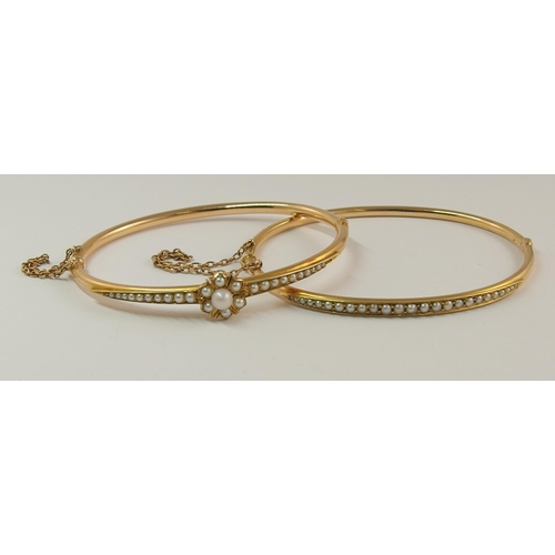 718 - A pair of pearl set bangles