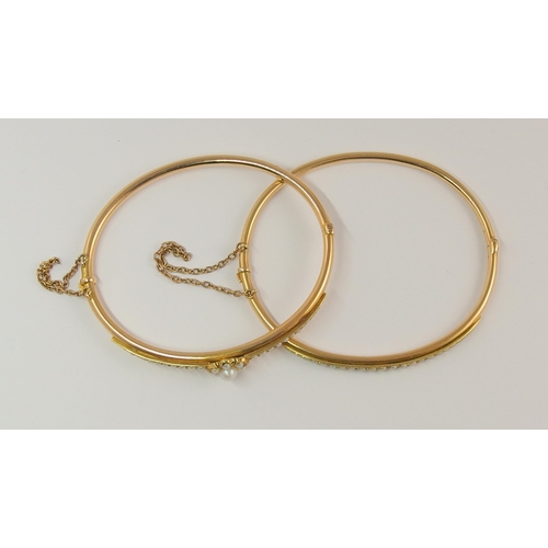 718 - A pair of pearl set bangles