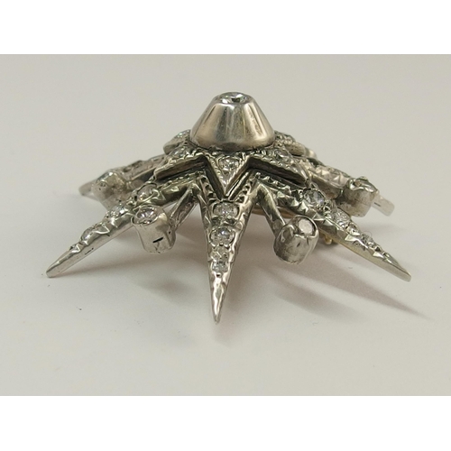 722 - A diamond set star brooch