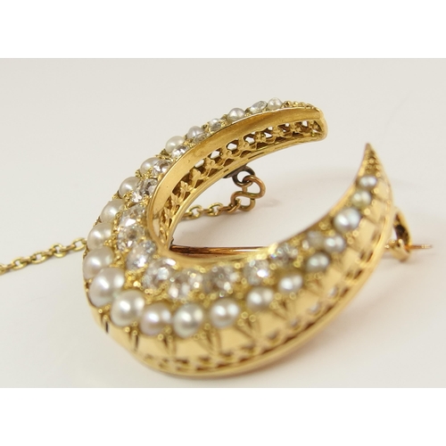 732 - A Victorian pearl and diamond crescent moon brooch