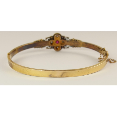 737 - An Etruscan revival bangle set with diamonds and a red gem