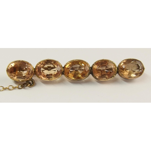 738 - A yellow metal topaz brooch