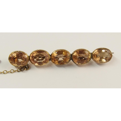 738 - A yellow metal topaz brooch