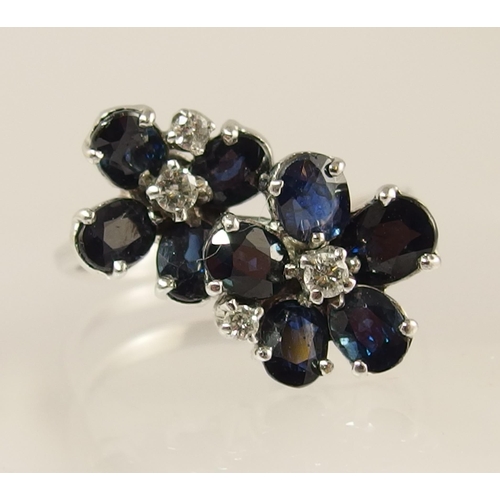 743 - An 18ct white gold sapphire and diamond flower ring