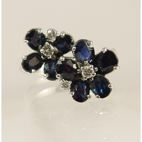 743 - An 18ct white gold sapphire and diamond flower ring