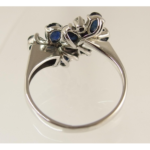 743 - An 18ct white gold sapphire and diamond flower ring