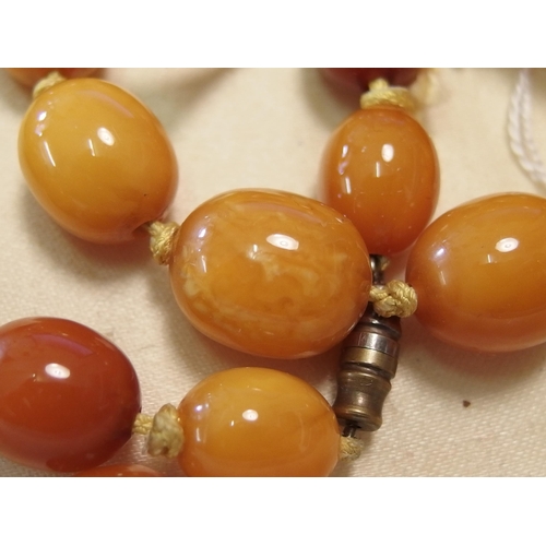 748 - Two amber coloured bead necklaces and a pair of earrings