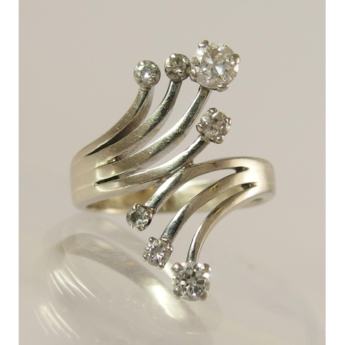 757 - A seven diamond spray style cluster ring