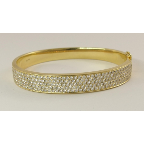 758 - An 18ct yellow gold diamond set bangle