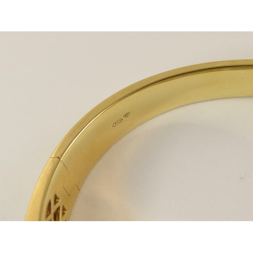 758 - An 18ct yellow gold diamond set bangle