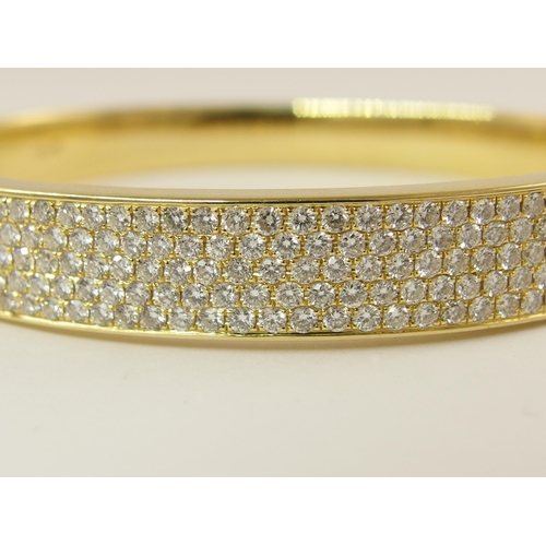 758 - An 18ct yellow gold diamond set bangle