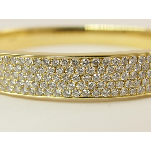 758 - An 18ct yellow gold diamond set bangle